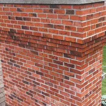 NextGen Contractors - a brick chimney on the roof of a house - Masonry/Concrete Near Me