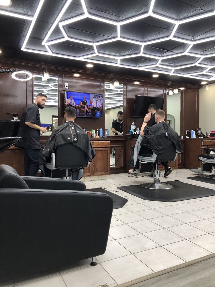 Cuts and More Barbershop Logo