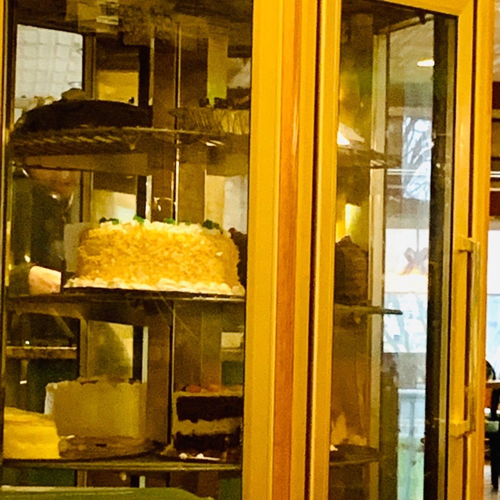 a glass case with a cake in it a glass case with a cake in it