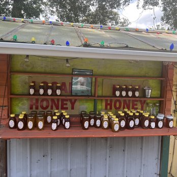Honor System Honey Stand - a display of honey jars - Honey Near Me - San Mateo, Florida Honor System Honey Stand - a display of honey jars - Honey Near Me - San Mateo, Florida