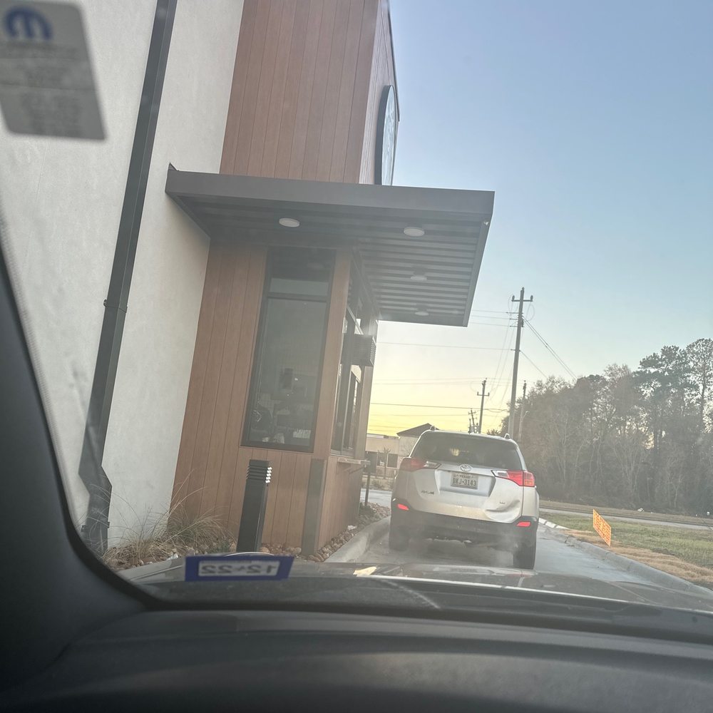 a view of a coffee shop from inside a car a view of a coffee shop from inside a car