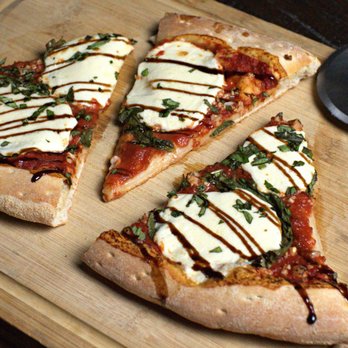 No Name Pizza - four slices of pizza on a cutting board - Pizza Near Me - Lawton, Oklahoma No Name Pizza - four slices of pizza on a cutting board - Pizza Near Me - Lawton, Oklahoma