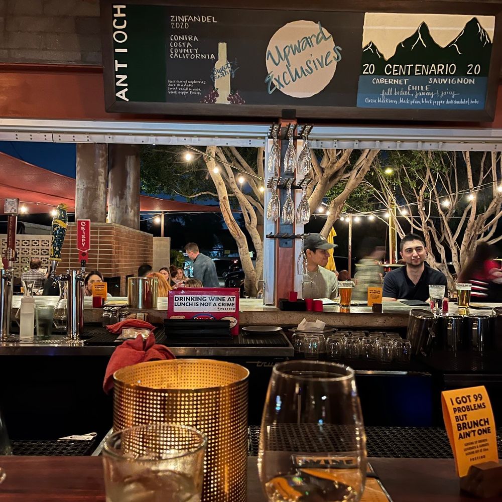 Postino Central - a view of a bar with people sitting at it - Wine Bars Near Me - Phoenix, Arizona Postino Central - a view of a bar with people sitting at it - Wine Bars Near Me - Phoenix, Arizona