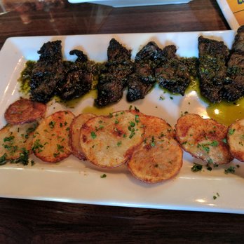 Taberna Tapas - Grilled skirt steak with Chimichurri-loved and sliced seasoned poatoes - Spanish Near Me - Durham, North Carolina Taberna Tapas - Grilled skirt steak with Chimichurri-loved and sliced seasoned poatoes - Spanish Near Me - Durham, North Carolina