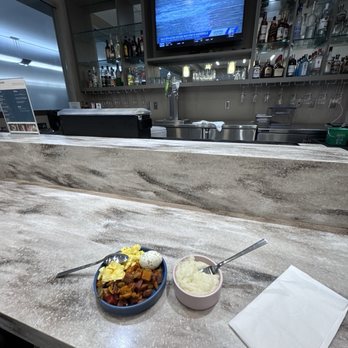 Escape Lounges - The Centurion Studio Partner - Bar seating area - typical breakfast selections 2/12/26 - Airport Lounges Near Me - Burlington, Kentucky