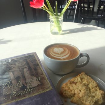 Fika Sisters Coffeehouse - Latte, and orange-white chocolate scone (which was yummy and moist). And who doesn't love flowers on their table! - Coffee & Tea Near Me - Sisters, Oregon Fika Sisters Coffeehouse - Latte, and orange-white chocolate scone (which was yummy and moist). And who doesn't love flowers on their table! - Coffee & Tea Near Me - Sisters, Oregon
