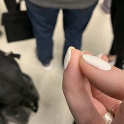 Elegant Nails & Spa - This shows the wet nail coming off while in line for airport security 9 hours after leaving the salon.