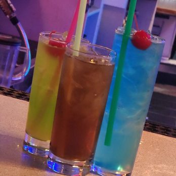 Crocodiles Nightclub - three different cocktails on a bar counter - Bars Near Me - Modesto, California Crocodiles Nightclub - three different cocktails on a bar counter - Bars Near Me - Modesto, California