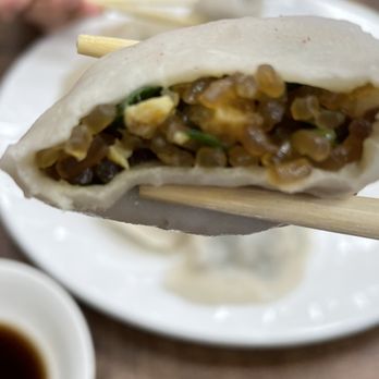 No Name Restaurant 無名小館 - a person holding a piece of food with chopsticks - Chinese Near Me - Flushing, New York