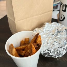 a cup of fries and a paper bag a cup of fries and a paper bag
