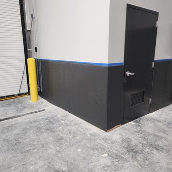 Machado Structures - a garage with a black door - Painters Near Me Machado Structures - a garage with a black door - Painters Near Me