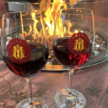 Marchesi Vineyards - two glasses of wine in front of a fire - Wineries Near Me - Hood River, Oregon