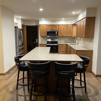 J D Coussens - a kitchen with a center island - General Contractors Near Me - Davenport, Iowa