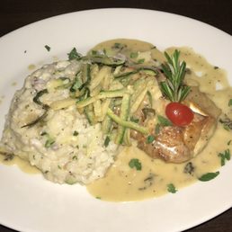 Rock fish with seafood risotto topped with crispy zucchini straws Rock fish with seafood risotto topped with crispy zucchini straws