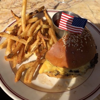 Le Diplomate - Burger that we were splitting and they brought it cut in half for us - Brasseries Near Me - Washington, DC, District of Columbia