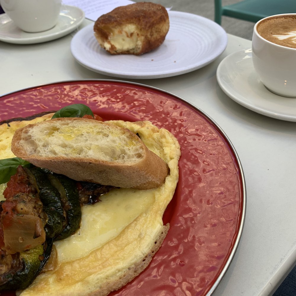 Piccolina - vegetarian omelette, with bomboloni and coffee in the background - Italian Near Me - Washington, DC, District of Columbia Piccolina - vegetarian omelette, with bomboloni and coffee in the background - Italian Near Me - Washington, DC, District of Columbia