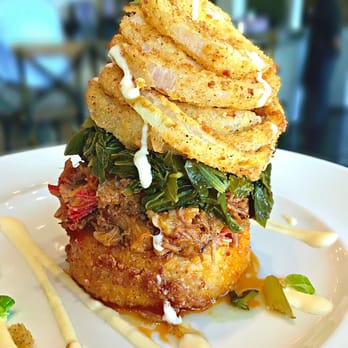 Front Porch - Pulled Pork Stack - fried Gouda grit cake topped with pulled pork, turnip greens, onions rings and white BBQ sauce - insanely good! - Bars Near Me - Hoover, Alabama