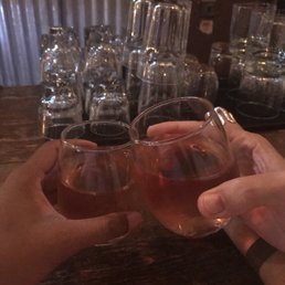 two people clinking glasses of wine