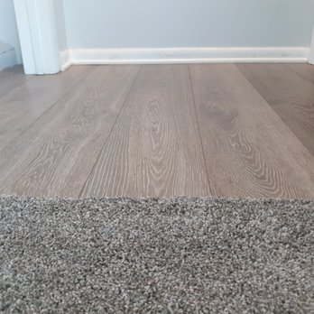 Divine Interiors - Tack and turn on carpet install and Vinyl flooring installation by front entryway. - Flooring Near Me