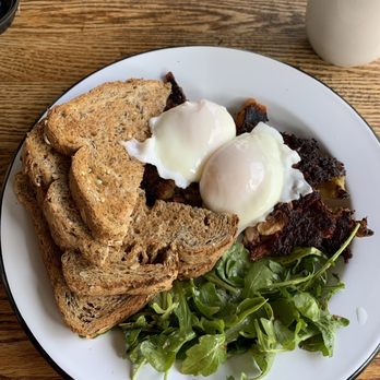 West Egg Bakery and Cafe - Corned beef hash and poached eggs, served with a side of multigrain toast and garlicky salad greens ($14) - Breakfast & Brunch Near Me - Woodbury, Connecticut