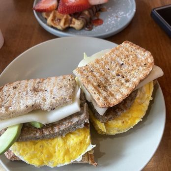 Arosa Cafe - Avocado Sausage, egg Breakfast added avocado on a gluten free bread - Coffee & Tea Near Me - Seattle, Washington Arosa Cafe - Avocado Sausage, egg Breakfast added avocado on a gluten free bread - Coffee & Tea Near Me - Seattle, Washington