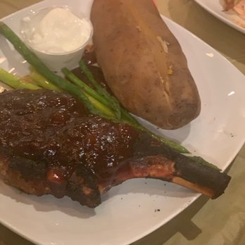 Pup's Steakhouse - Bone in Pork Chop, Baked Potato and Asparagus - Steakhouses Near Me - Wilson, North Carolina Pup's Steakhouse - Bone in Pork Chop, Baked Potato and Asparagus - Steakhouses Near Me - Wilson, North Carolina