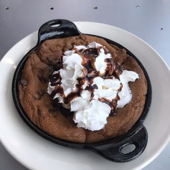 Sidewinders - Dessert- cast iron chocolate chip cookie with ice cream and whip cream - New American Near Me - Jackson, Wyoming Sidewinders - Dessert- cast iron chocolate chip cookie with ice cream and whip cream - New American Near Me - Jackson, Wyoming