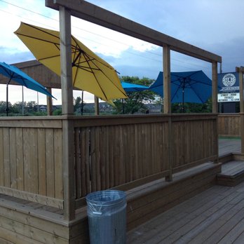 Great Lakes Brewery - Canada - Patio and GLB sign in the distance. (Storm clouds gathering!) - Breweries Near Me - Etobicoke, Ontario