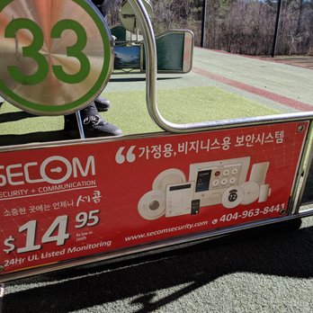 Paragon Golf - Korean advertisements in each hitting bay. - Golf Near Me - Duluth, Georgia