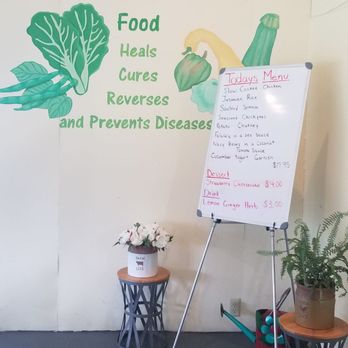 LT Organic Farm & Restaurant - a whiteboard with a list of vegetables on it - Health Markets Near Me - Waukee, Iowa