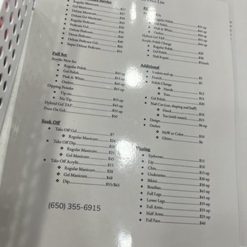Refresh Nail Care - Price list as of 7/16/22 - A laminated price list from Refresh Nail Care in Pacifica, CA, displaying various nail and waxing services. The list includes prices for manicures, pedicures, gel polish, acrylics, and waxing treatments such as eyebrows, lips, chin, and full face. It also details additional options like hot stone massages and paraffin treatments, with prices ranging from $5 to $65. The contact phone number is provided at the bottom of the list. - Nail Salons Near Me - Pacifica, California