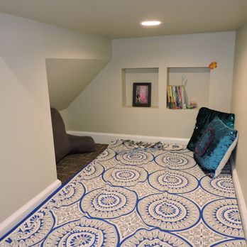Runyan Brothers Construction - a bedroom with a blue and white rug - General Contractors Near Me - Howell, Michigan Runyan Brothers Construction - a bedroom with a blue and white rug - General Contractors Near Me - Howell, Michigan