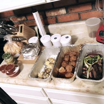 Comal - Left to right: chips and salsas, tortillas, containers of rice & beans, elote, albondigas, carne asada. - Mexican Near Me - Berkeley, California