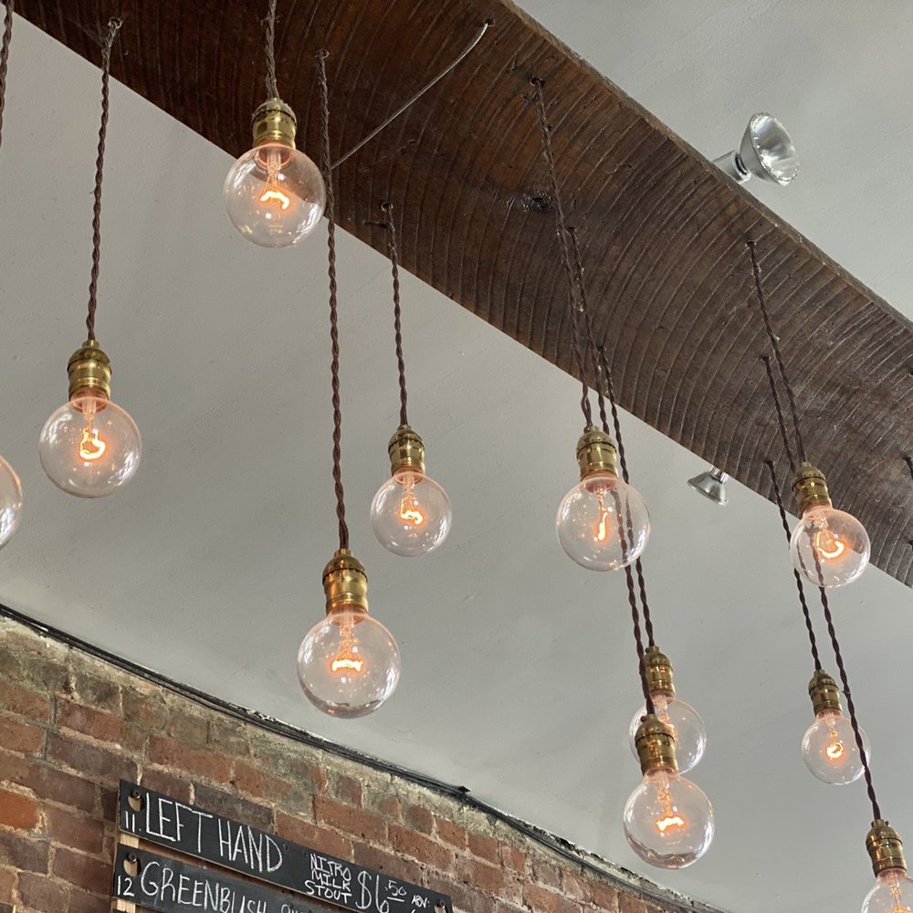 Arcadium - a bunch of light bulbs hanging from the ceiling - Bars Near Me - Lexington, Kentucky