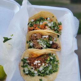 three tacos in a styrofoam container