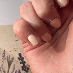 The top coat wasn't applied properly because there are gel bubbles present.
