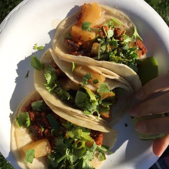 Garcia's Tamales - a person holding a plate of tacos - Food Trucks Near Me Garcia's Tamales - a person holding a plate of tacos - Food Trucks Near Me