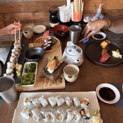 Sushi Genki - assorted sushi and nigiri. the tuna yuzu tartare hand roll (pictured on the wood board, sprouts on top) is particularity tasty!