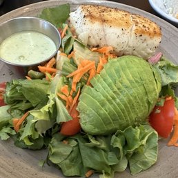 Green salad with added halibut steak and avocado