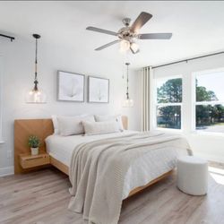 Airbnb master bedroom set up, bedside lighting, curtain, picture and bed install. We can set up your Airbnb!