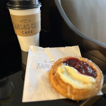 Made In KC Cafe - To-go coffee cup from Made in Kansas City Cafe with a berry-and-cream-cheese danish sitting on the pastry bag. - Cafes Near Me - Kansas City, Missouri Made In KC Cafe - To-go coffee cup from Made in Kansas City Cafe with a berry-and-cream-cheese danish sitting on the pastry bag. - Cafes Near Me - Kansas City, Missouri
