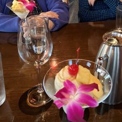 Our vanilla ice cream dessert arrived in cocktail goblets with (another) orchid.