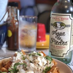 La Tortilleria - Chilaquiles with chicken and large bottle of chilled Aqua de Piedra (sparkling mineral water) on a very warm Spring Day!