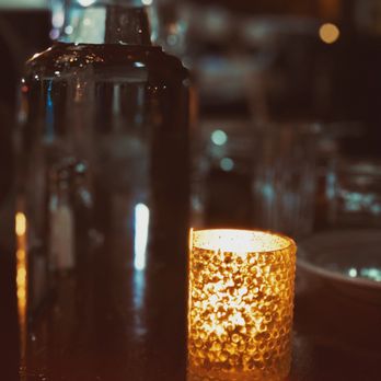 Cafe Zola - a candle and a glass on a table - French Near Me - Ann Arbor, Michigan Cafe Zola - a candle and a glass on a table - French Near Me - Ann Arbor, Michigan