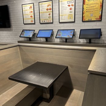 Brine - a table and benches in a restaurant - Chicken Shop Near Me - New York, New York