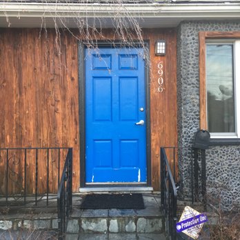 Performance Renovations - BEFORE: damaged (original?) wood door. Poor quality wood around door and windows. Porch light with no switch to control it. - General Contractors Near Me - Sherwood, Oregon