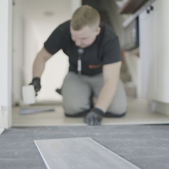 Homze - a man laying tile on the floor - Flooring Near Me - Vancouver, Washington
