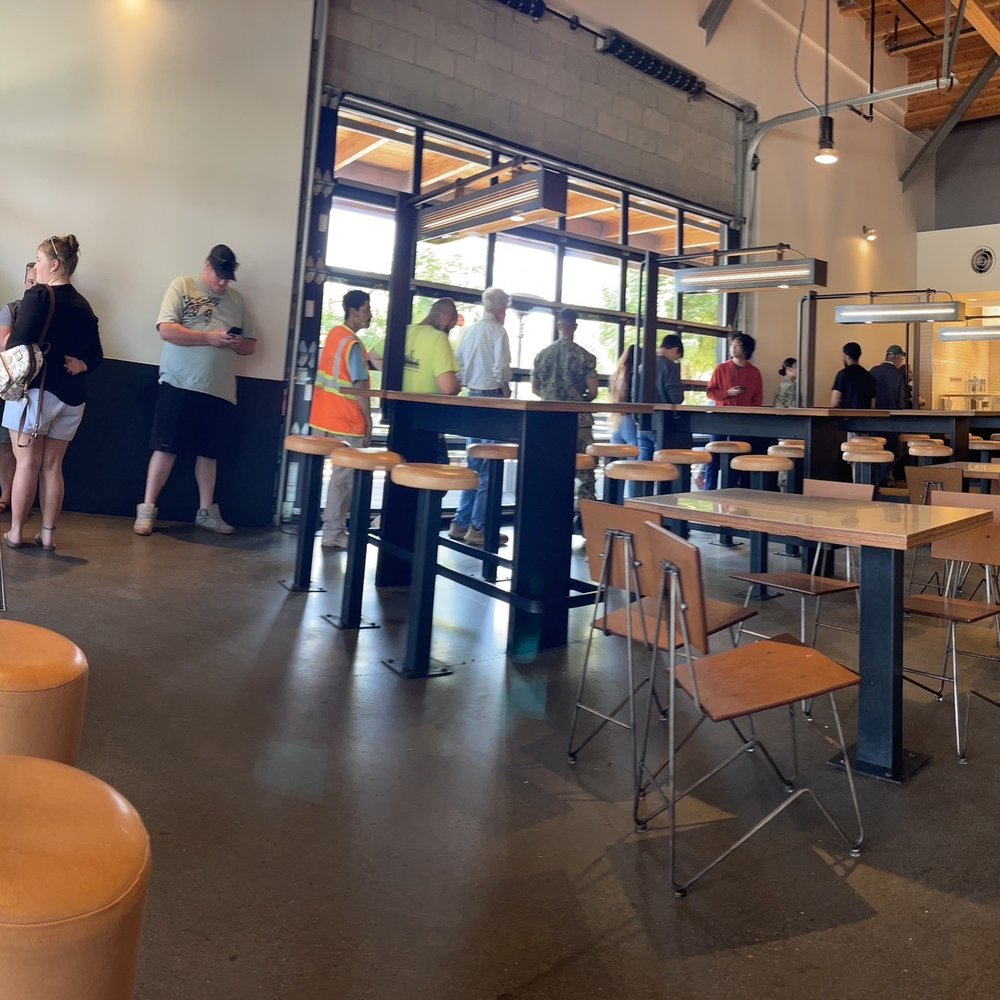 Customer line up and only 1 person behind the counter helping them. Customer line up and only 1 person behind the counter helping them.