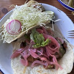 Fish taco up top and al pastor on the bottom. Fish taco up top and al pastor on the bottom.