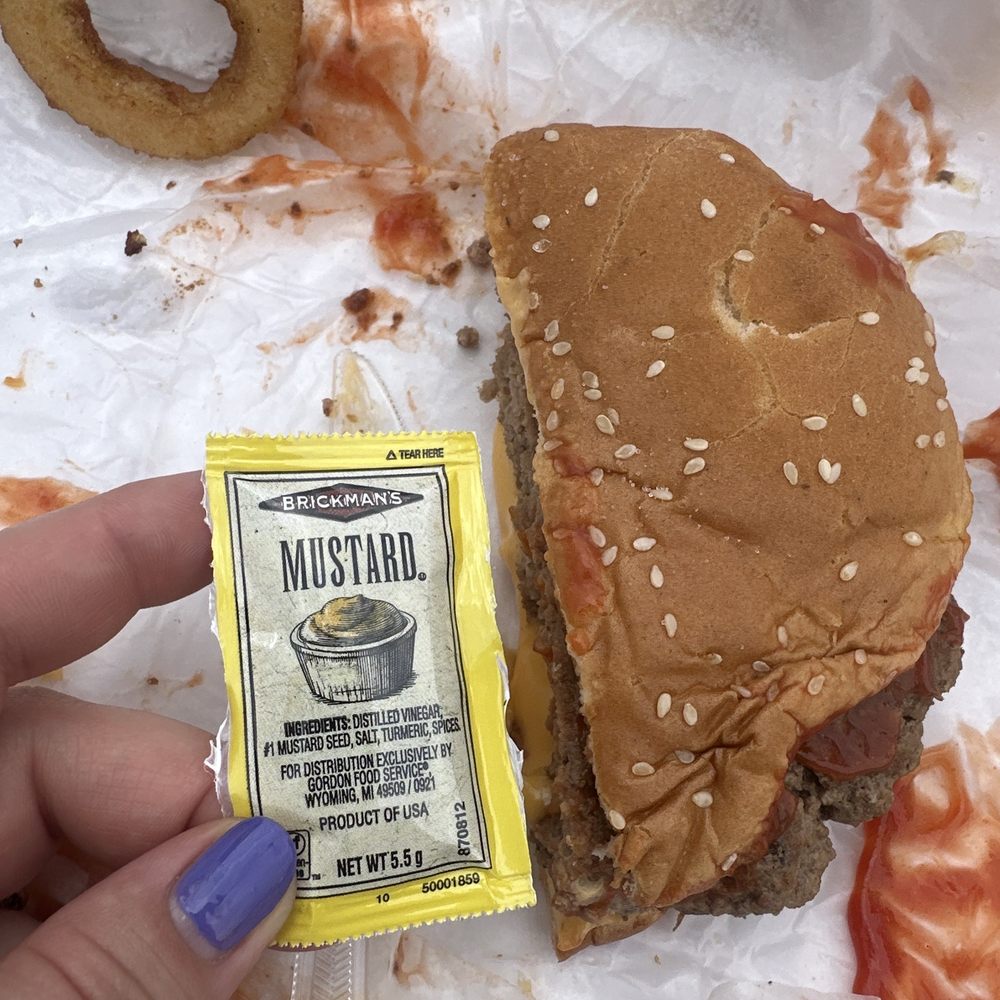 West Pier Drive-In - This is half of a cheeseburger. It's HUGE in comparison to the packet size - Burgers Near Me - Sault Ste. Marie, Michigan